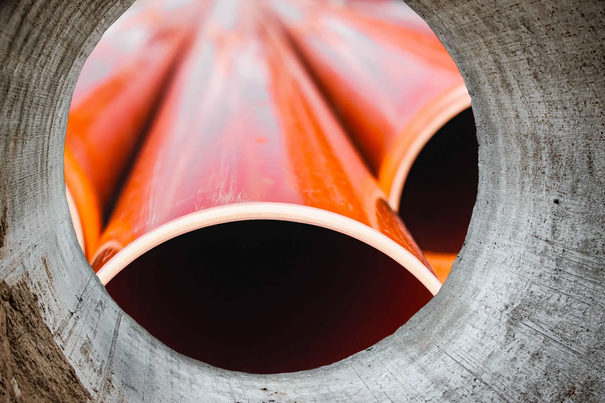 Sewer-Pipe-Technology a pile of sewer pipe looking through another Sewer Pipe